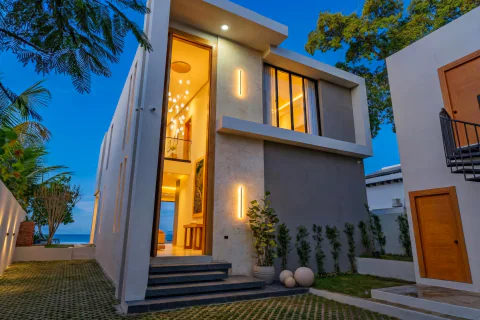 Beachfront villa entrance lit at dusk