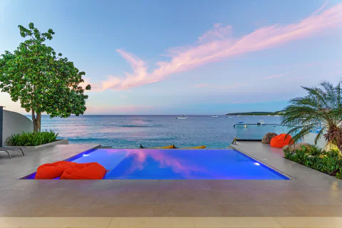 Infinity pool overlooking the ocean at sunset