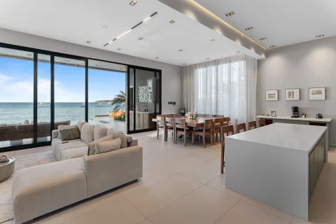Open-plan living and dining room with daytime ocean views