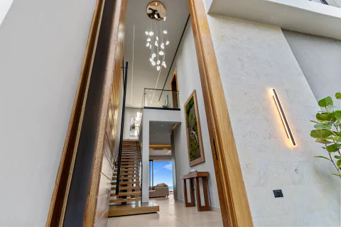 Entrance hall with sculptural chandelier and floating staircase